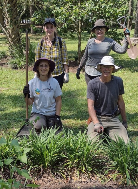 Four volunteers posing in a garden